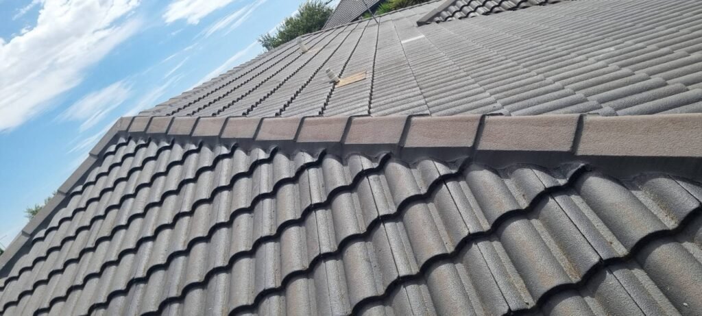 Close-up of a grey tiled roof and ridge capping