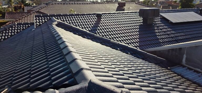 After: restored charcoal tiled roof with ridge and hip capping, evaporative cooler and solar panel in Sydenham