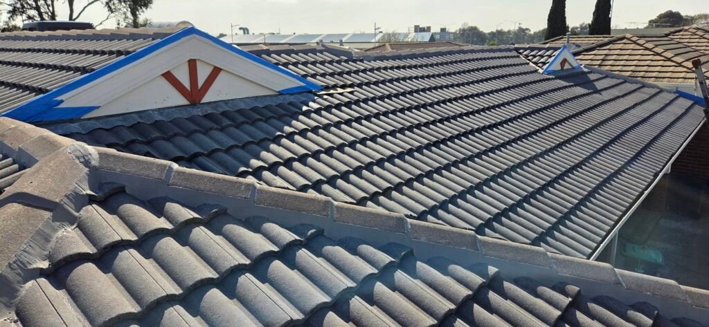 Gable ends masked with blue tape during a full roof restoration in Sydenham