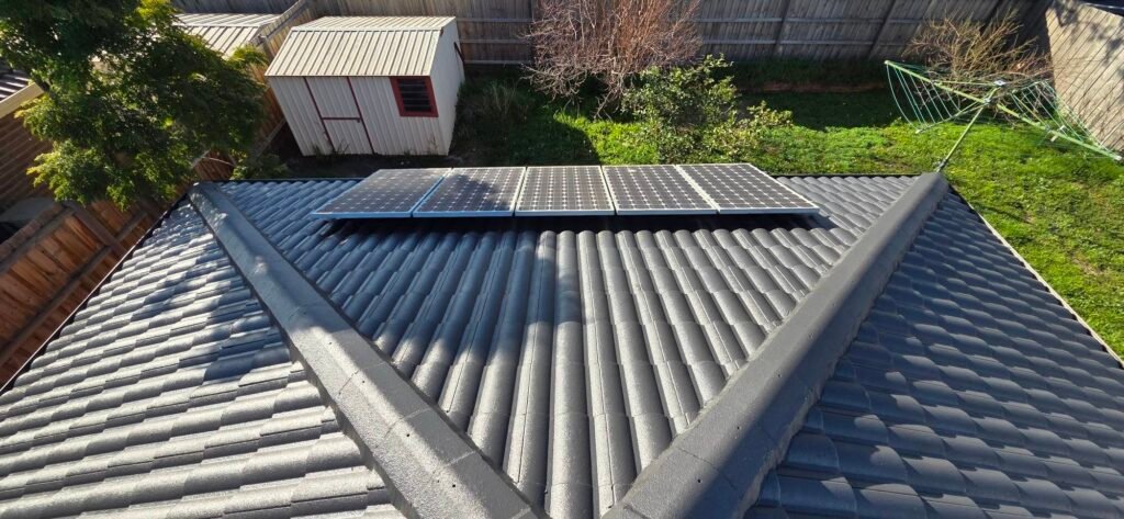 After: restored charcoal tiled roof with five solar panels in Sydenham