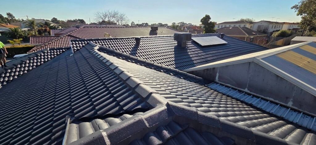 After: restored charcoal tiled roof with solar panel and roof vents in Sydenham