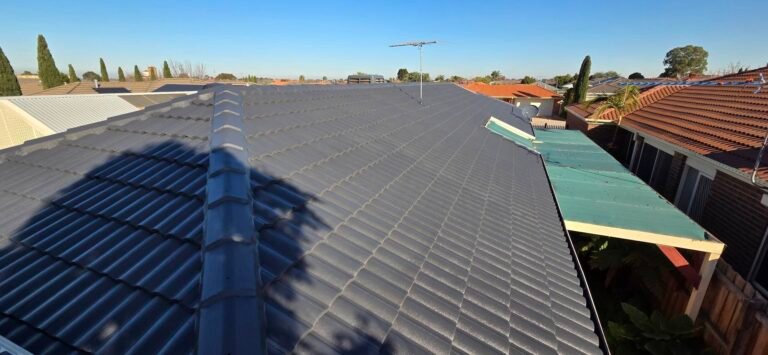 After: charcoal restored tiled roof with TV antenna and satellite dish in Sydenham