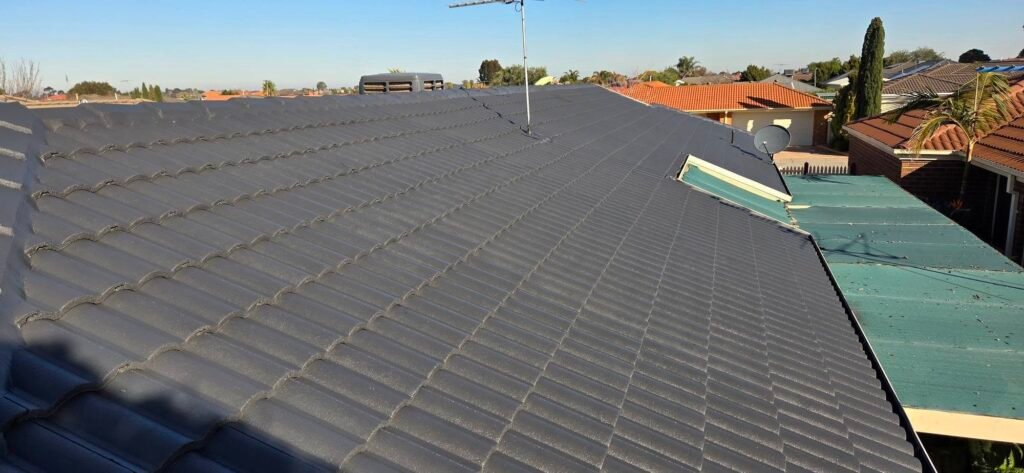 After: restored charcoal tiled roof with antenna and evaporative cooler in Sydenham