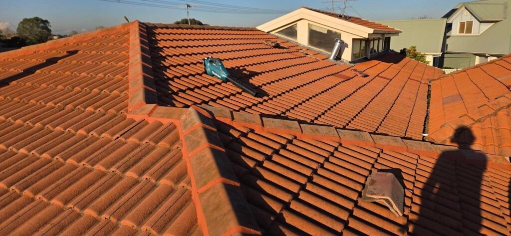 Completed ridge capping repoint on a tiled roof in Hillside