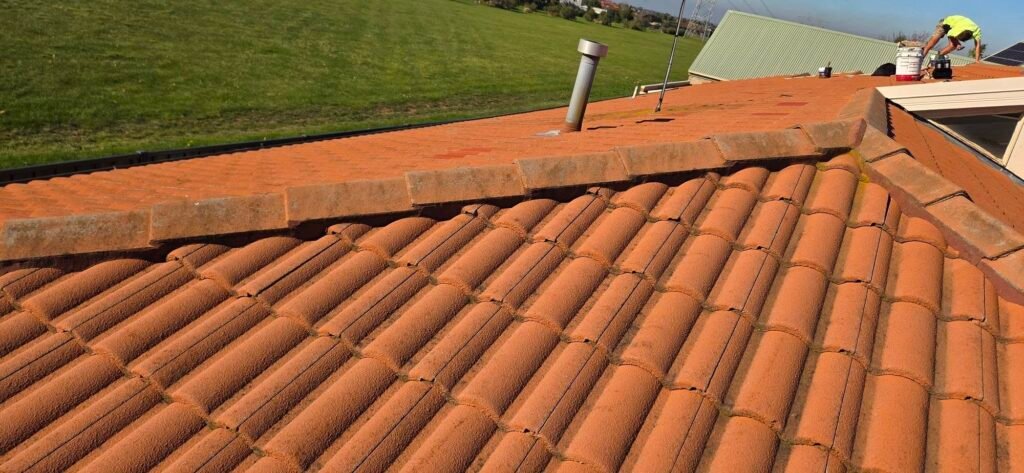 Before: weathered ridge capping with aged pointing on a tiled roof in Hillside