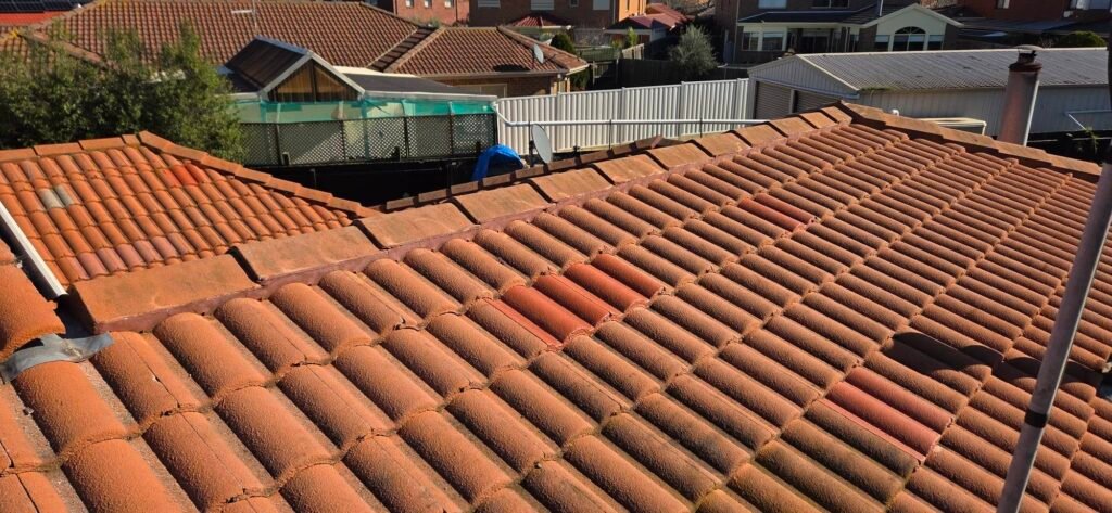 Aged, cracked ridge pointing on a tiled roof in Hillside before repointing