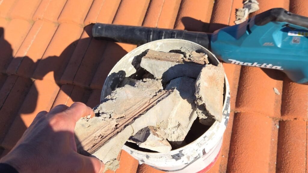 Old ridge pointing removed ahead of repointing on a tiled roof in Hillside